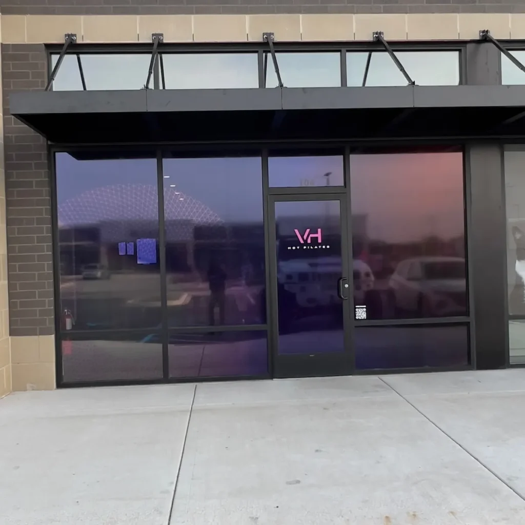 Commercial storefront with tinted glass front and entry door in St. John, IN