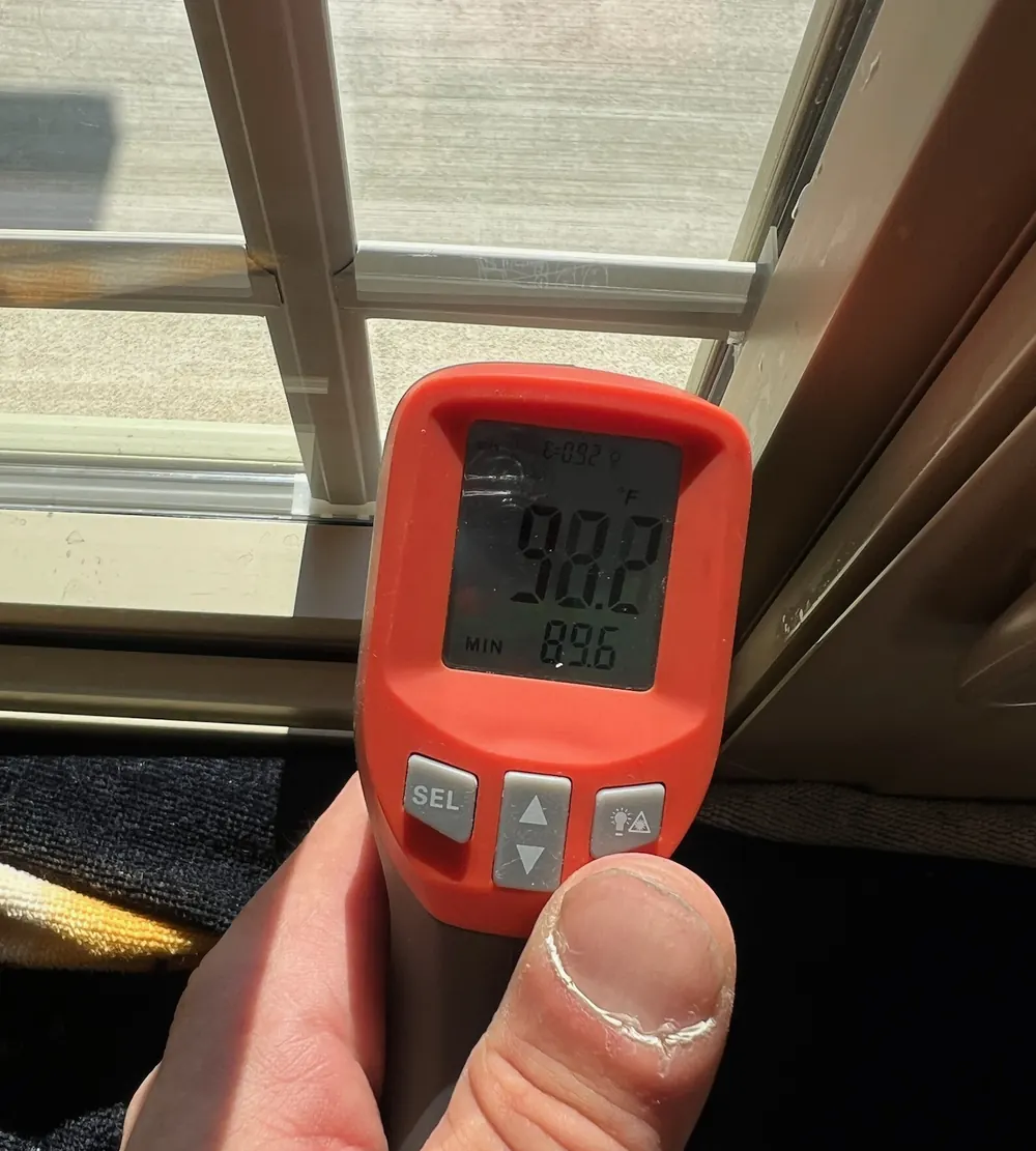 Infrared thermometer reading taken at a window for a solar control window film job in St. John, IN