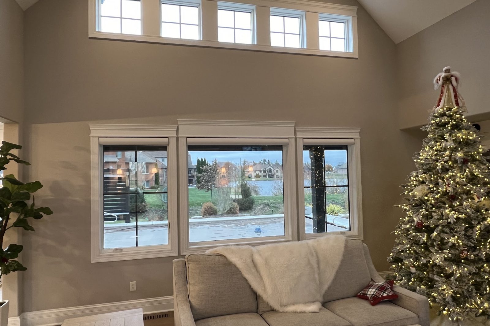Living room with tall picture windows and transom windows treated with window film