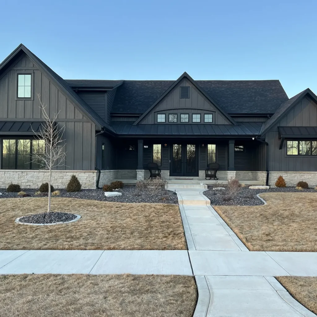 Exterior of a modern black farmhouse-style home with residential window tinting in St. John, IN